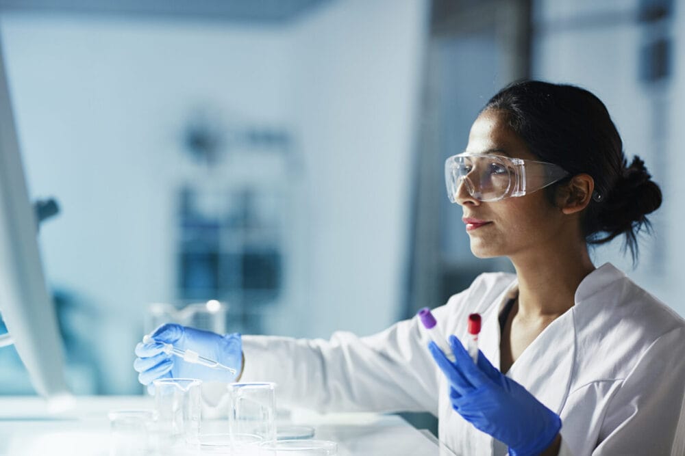 A medical researcher working at a laboratory bench