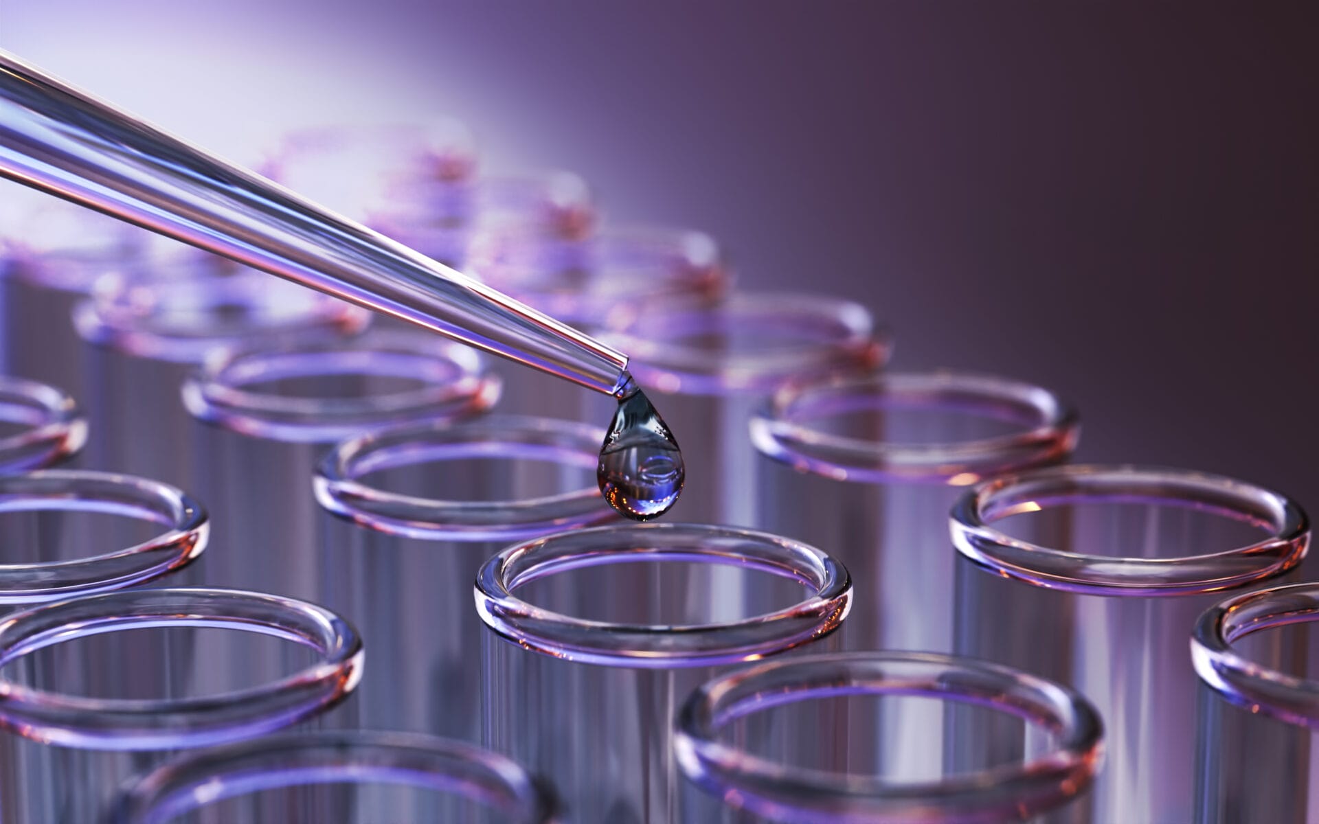 A pipette dispensing liquid into a row of test tubes